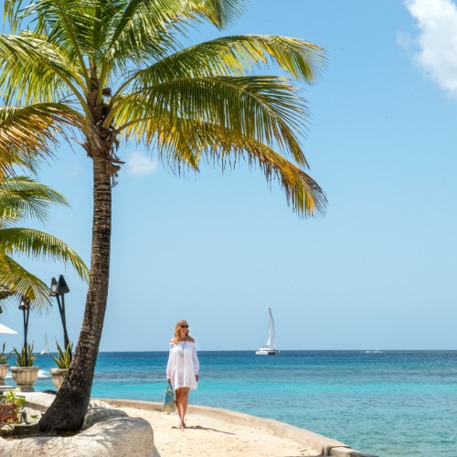 Woman walking on the beach at Coral Reef Club