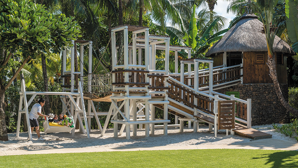 Kids on play equipment in the kids club at Shangri-la Le Touessrok in Mauritius