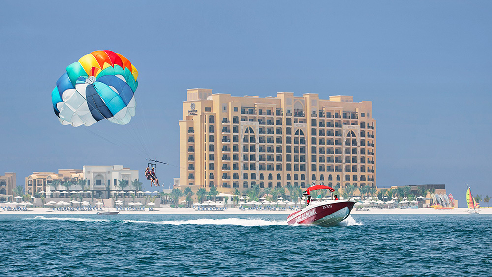 Person parasailing at Doubletree by Hilton Resort Marjan Island
