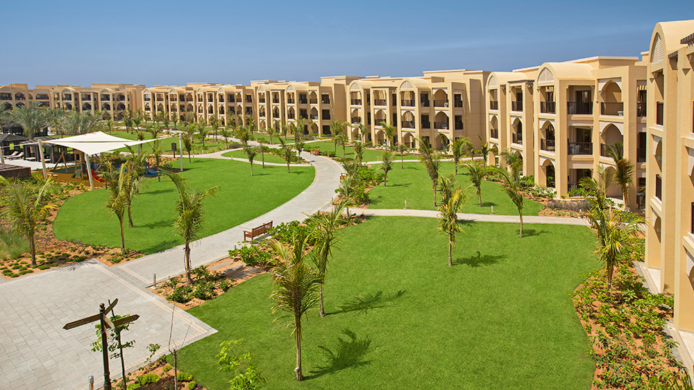 Grassed area in front of villas at Doubletree by Hilton Resort Marjan Island