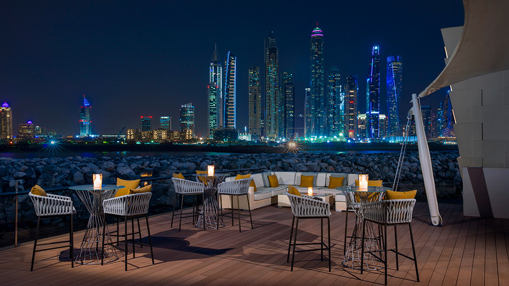 Outdoor dining at night at Manor House at One&Only The Palm