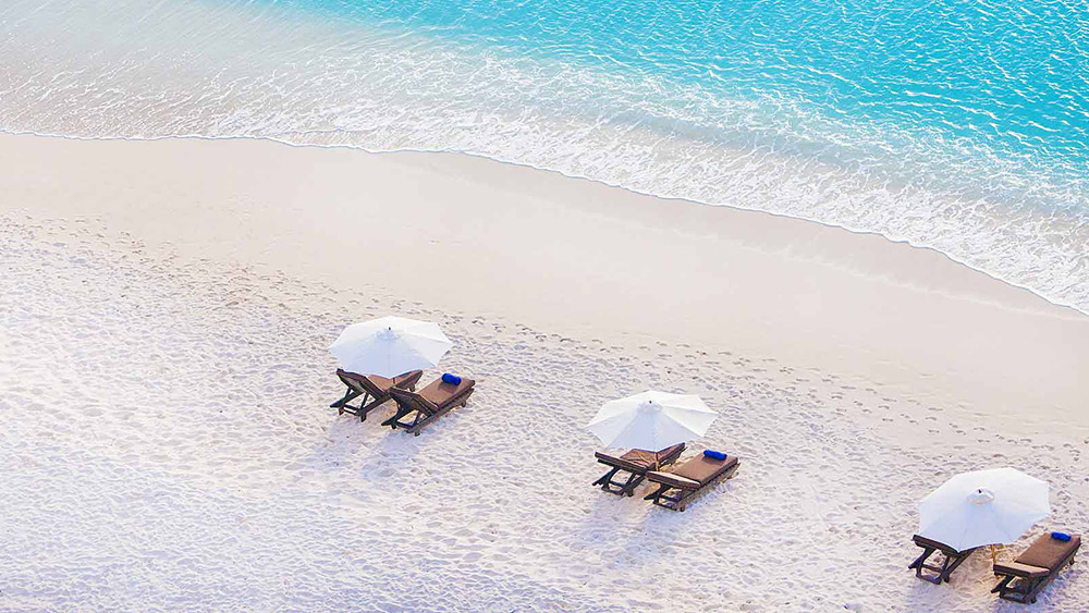 Sun loungers on the beach at Cocos Hotel