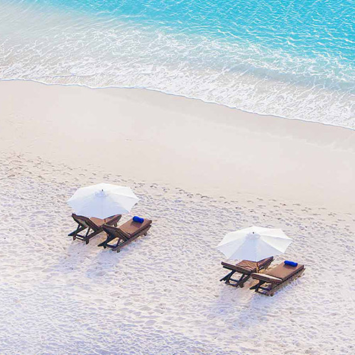 Sun loungers on the beach at Cocos Antigua