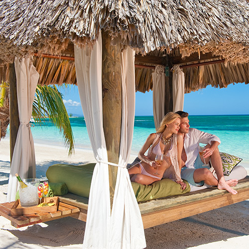 Couple in a cabana on the beach at Sandals Montego Bay