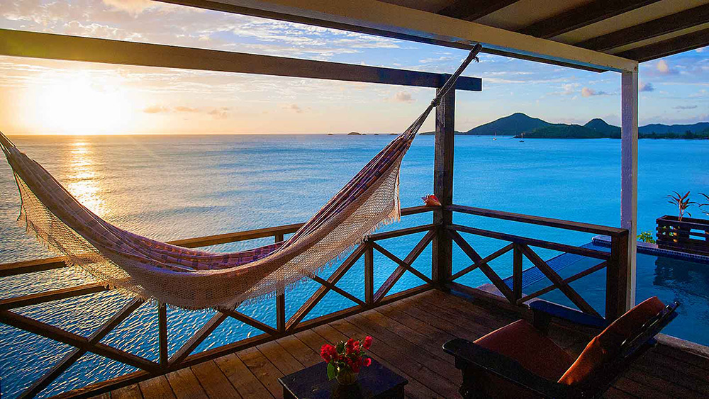 Hammock on a balcony at sunset at Cocos Hotel