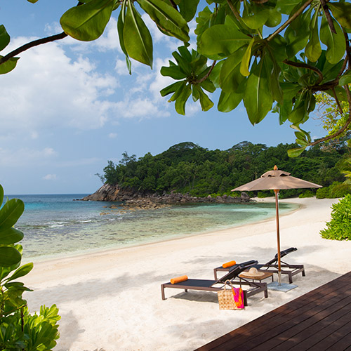 Sun loungers on the beach at AVANI Barbarons Seychelles