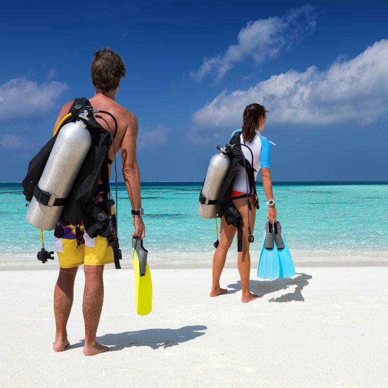 Scuba diver couple with diving equipment