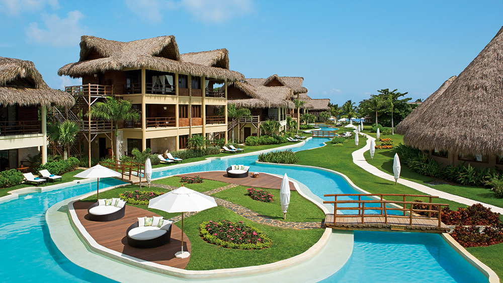 Winding pool past suites at Zoetry Agua Punta Cana