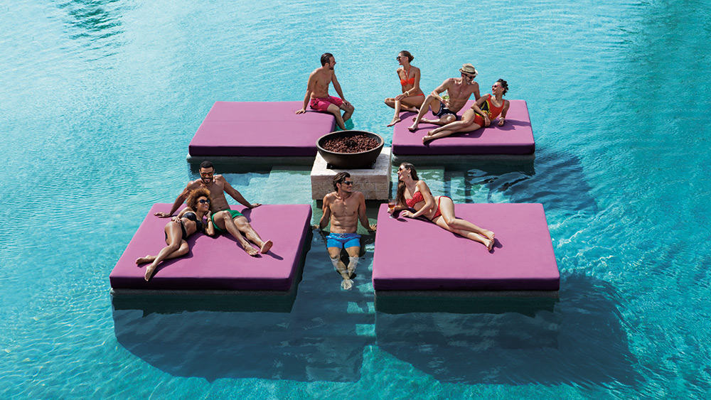 Friends on pontoons in the pool at Breathless Riviera Cancun