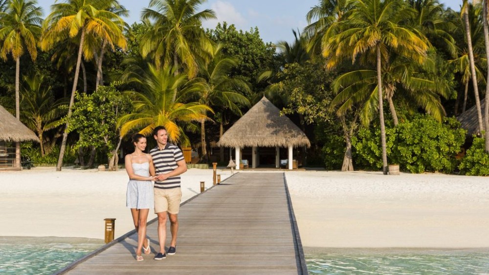 Couple on the jetty at Veligandu Island Resort & Spa