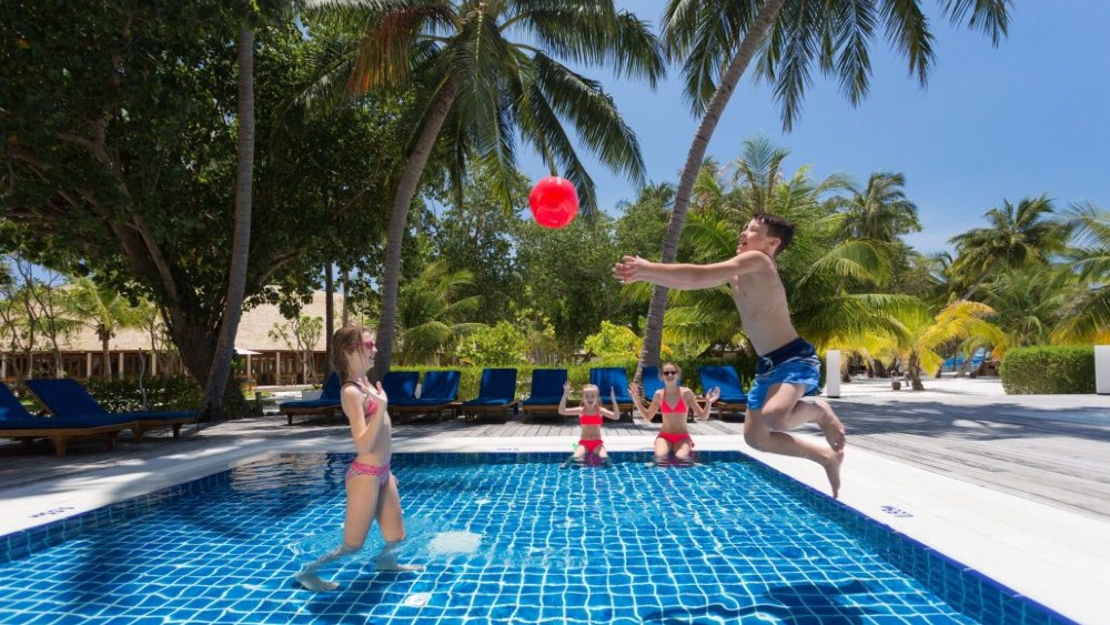Children playing in a pool at Meeru Island Resort