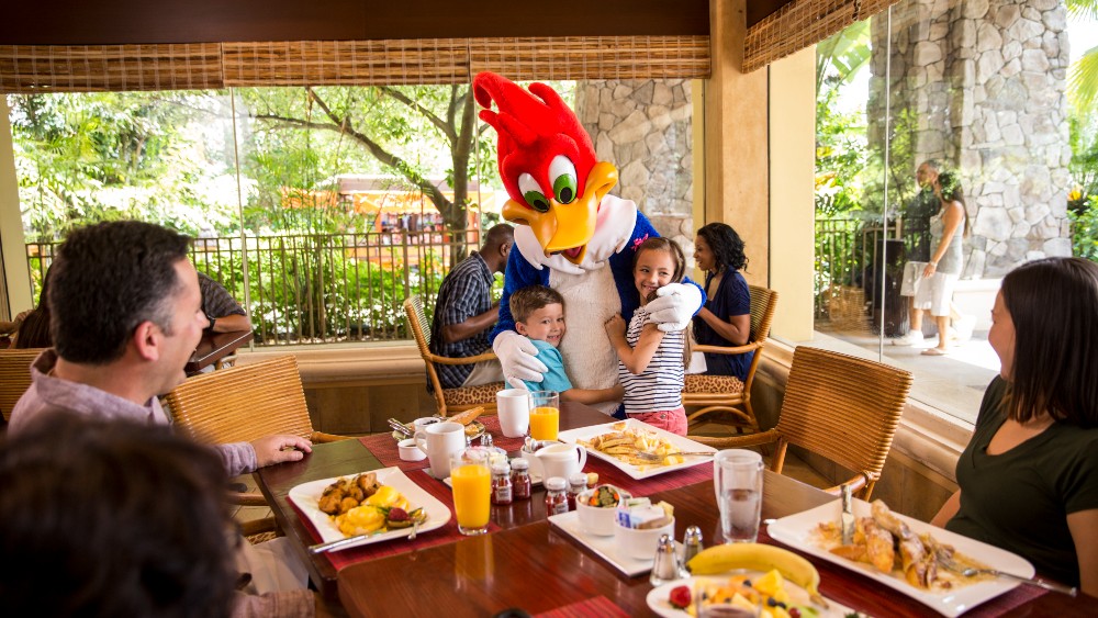 Character visiting a family while dining at Loews Royal Pacific Resort at Universal