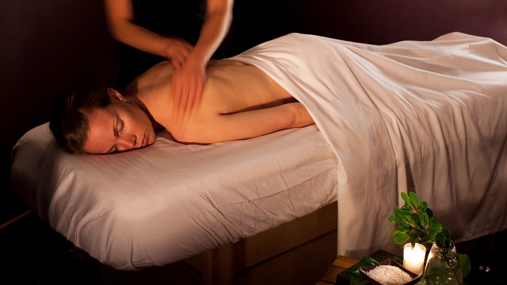 Woman being massaged at Kimpton Hotel Eventi
